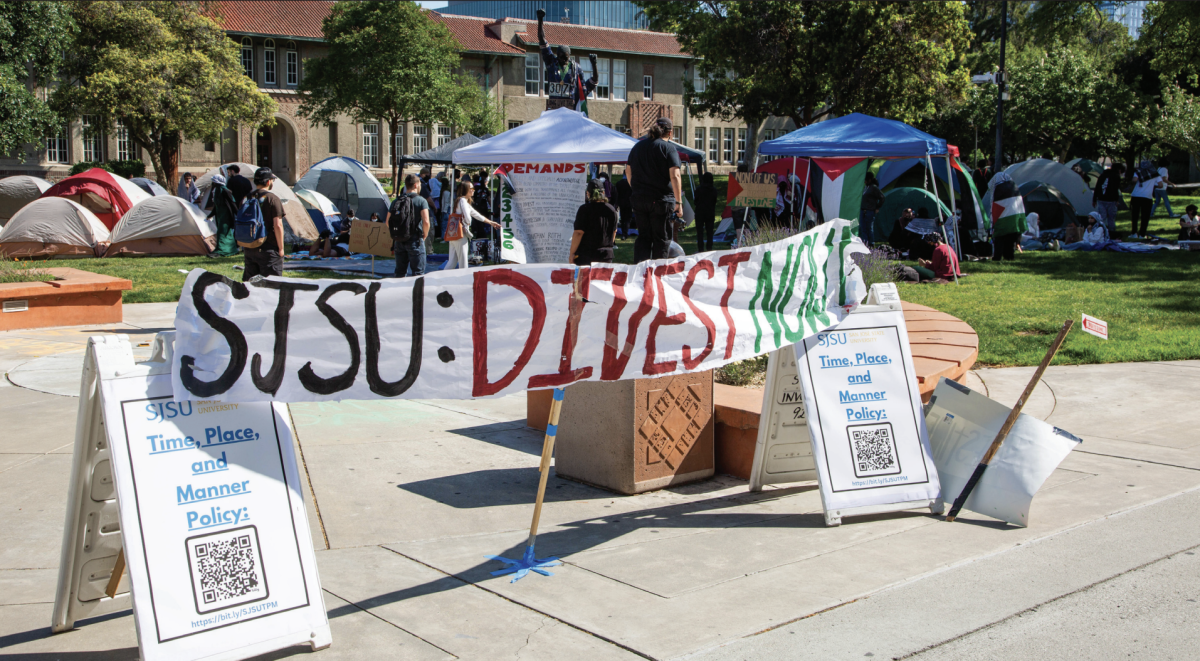 A pro-Palestinian banner displayed on top of Time, Place and Manner sign near Smith and Carlos Lawn encampment at the end of the 2024 Spring semester.
