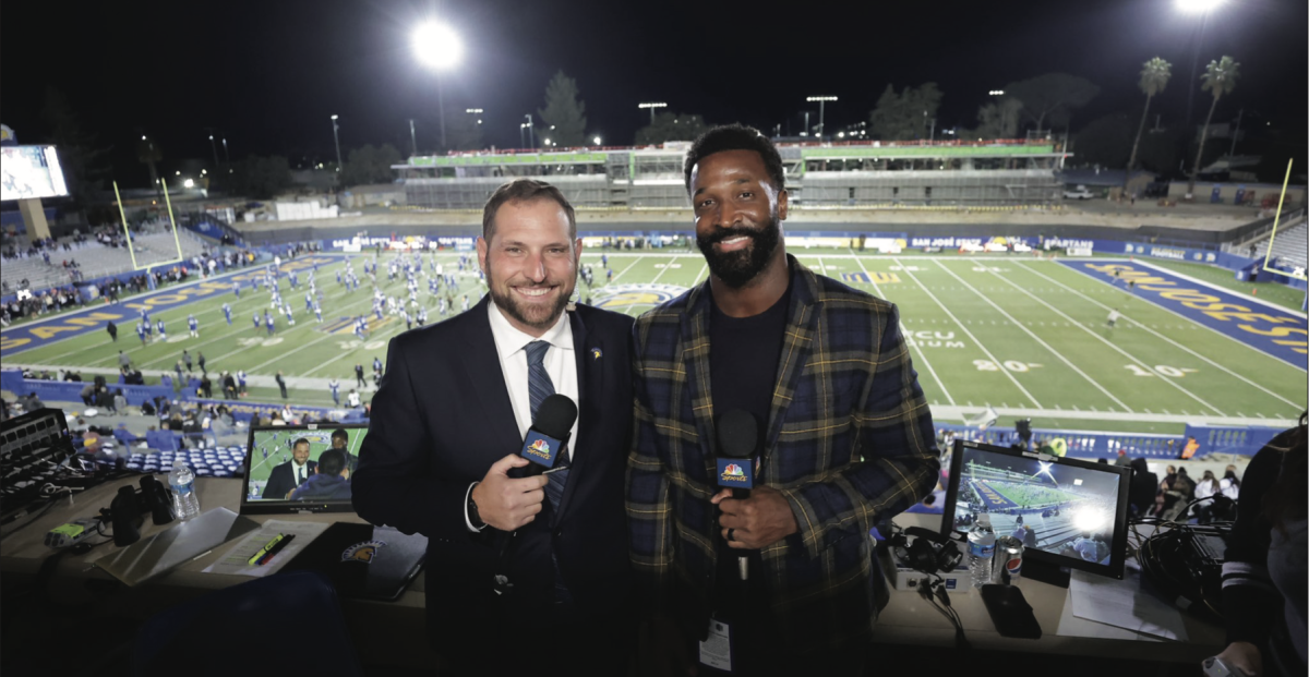 San José State alumni and sports broadcasters Justin Allegri (left) and James Jones (right) pose for a photo during a Spartan football game.