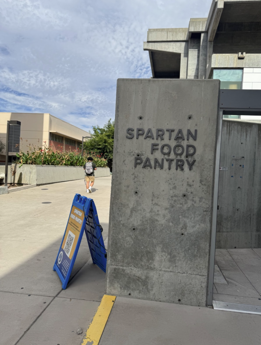 A student walks past the Spartan Food Pantry, which oﬀ ers food assistance, located near Diaz Compean Student Union.