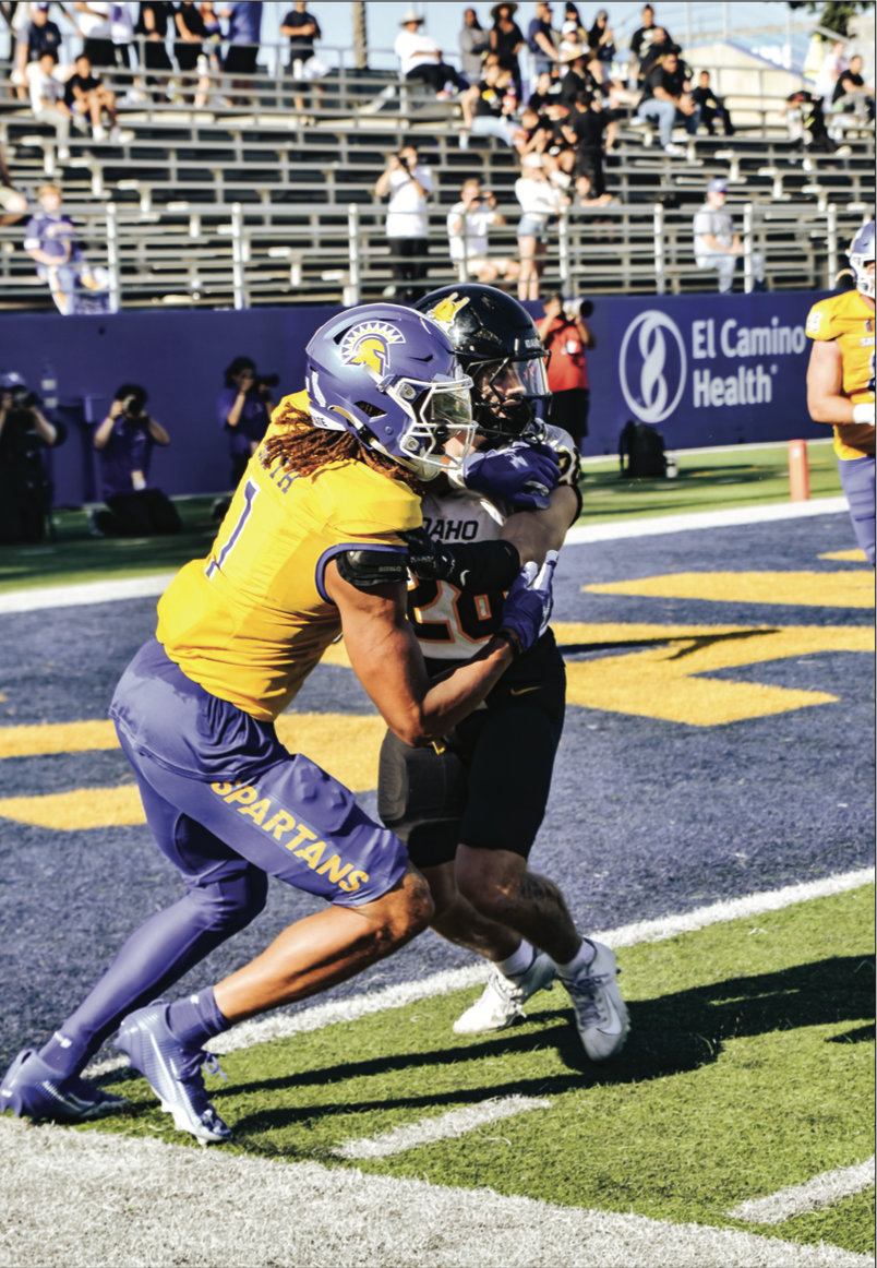 Spartans wide receiver Leland Smith tries to overpower Vandal defender on Saturday.