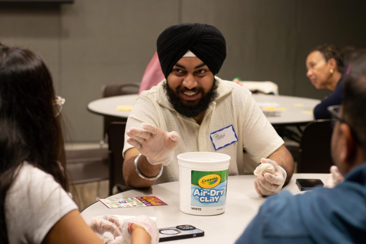 Prabhjot Singh, an SJSU first-year software engineering student, shapes a clay diya with friends at Monday’s Diwali celebration hosted in the Student Union.