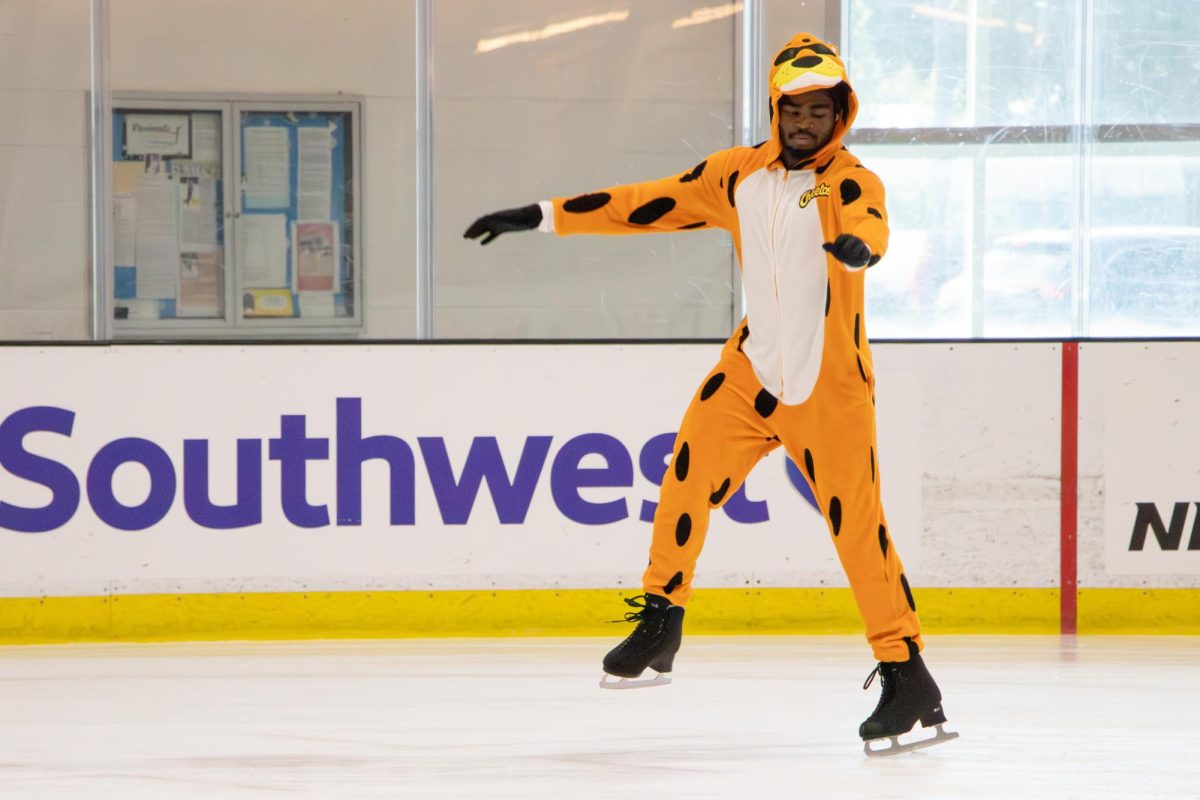 ochi Evuka, San José State University fourth-year aerospace engineering student, competes in the
Advanced 1 Solo Compulsories dressed as Chester Cheetah at the Tricks for Treats competition on Sunday