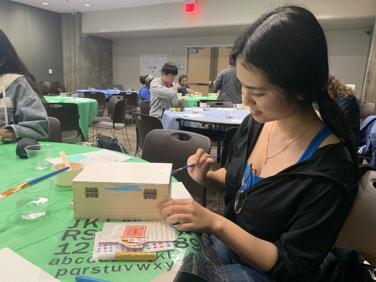 Attendee and SJSU fi rst-year biology student Alina Tu paints her time capsule at the Time Through Legacy event.