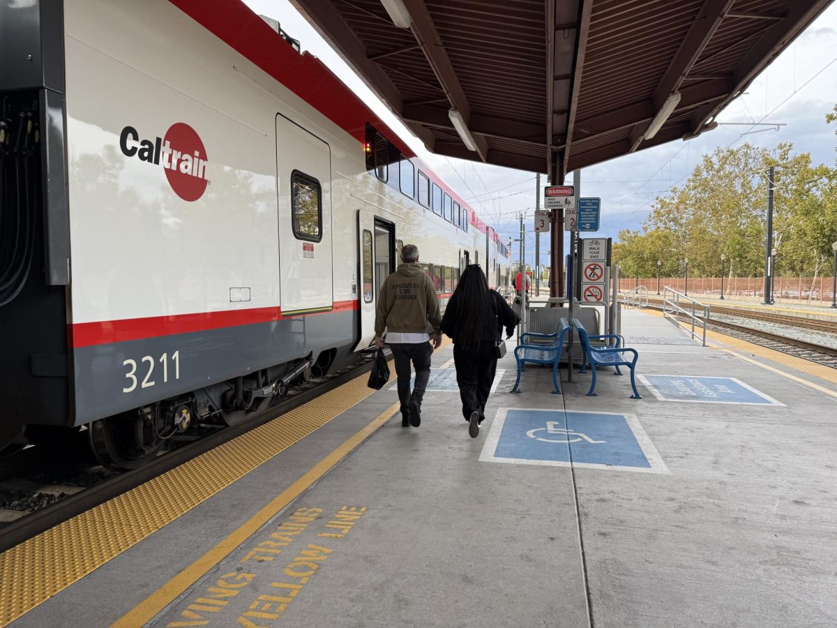 People walk to their bus stop at the Caltrain San José Diridon Station located at 65 Cahill Street, around a mile and a half west of the San José State campus.