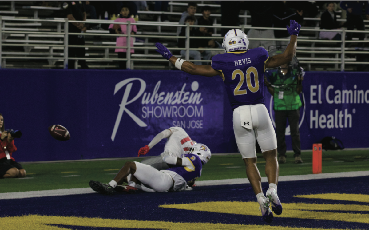 Spartans defensive back Isiah Revis (20) celebrates as teammate Runye Norton forces a pass breakup against Lobos Wide receiver Michael Buckley.