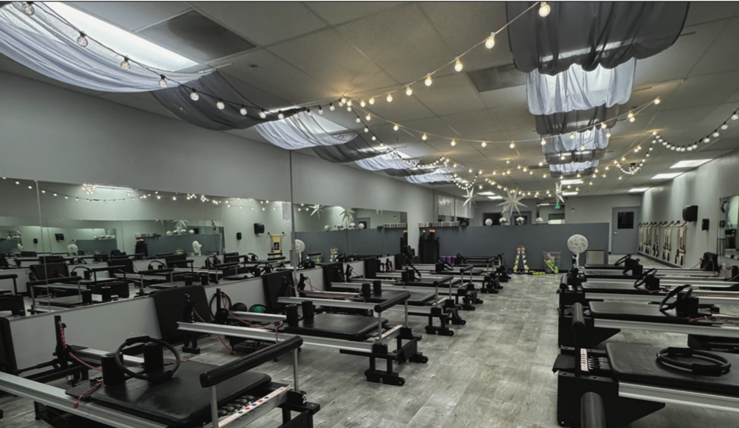 IM=X Pilates studio located in Gilroy has rows of Reformer pilates stations located inside the establishment.