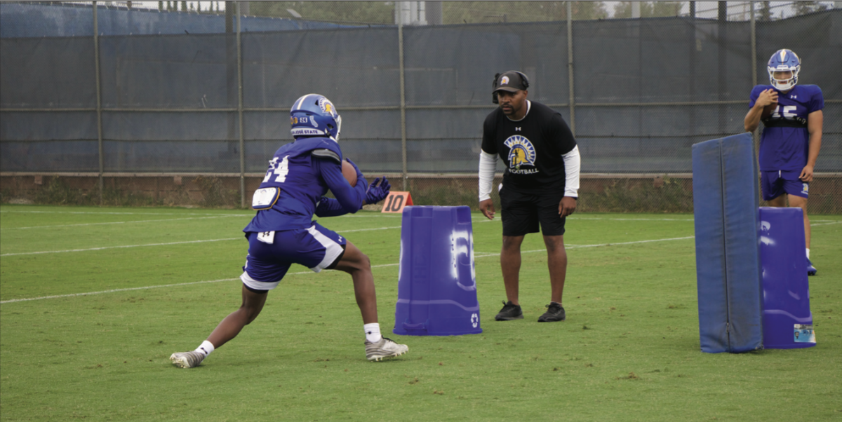 SJSU freshman running back Sir Autry (24) attempts a drill while running backs coach Michael Smith observes at wednesday morning practice.