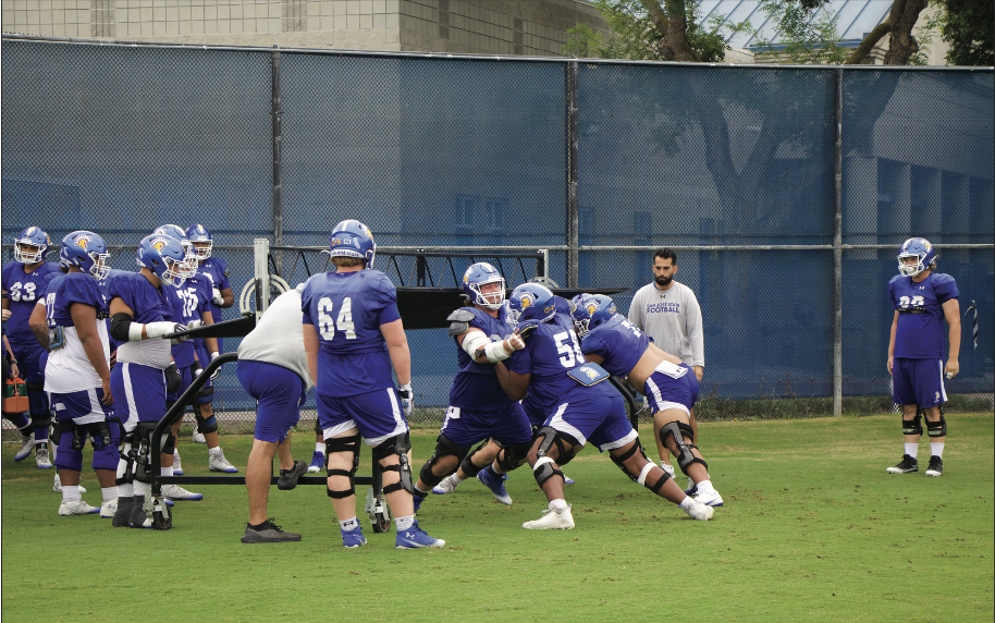SJSU offensive linemen run drills at practice preparing for Utah State. The group has given up 8 sacks for 58 yards.