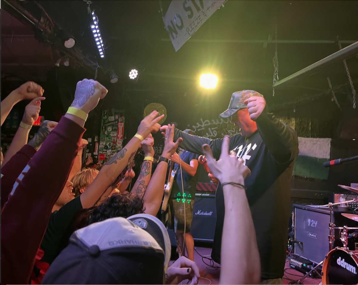 Earth Crisis vocalist, Karl Buechner, lends the microphone to attendees singing along to the song "Wrath of Sanity."
