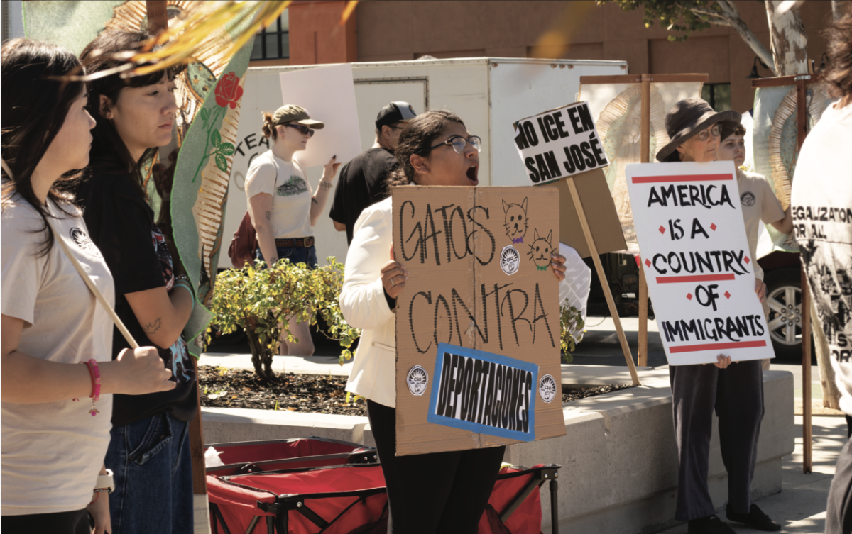 Brisa Moreno holds a sign protesting Immigration and Customs Enforcement (ICE) on Sunday Sept. 21. Moreno is chief of staff for San José Councilmember Peter Ortiz.
