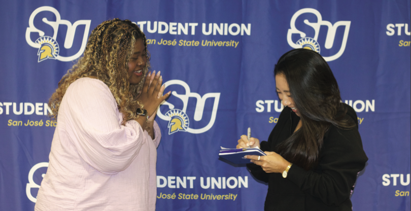 SJSU Associated Students director of student resource affairs Teairra Brown (left) asks for an autograph from Valkyries head coach Natalie Nakase.