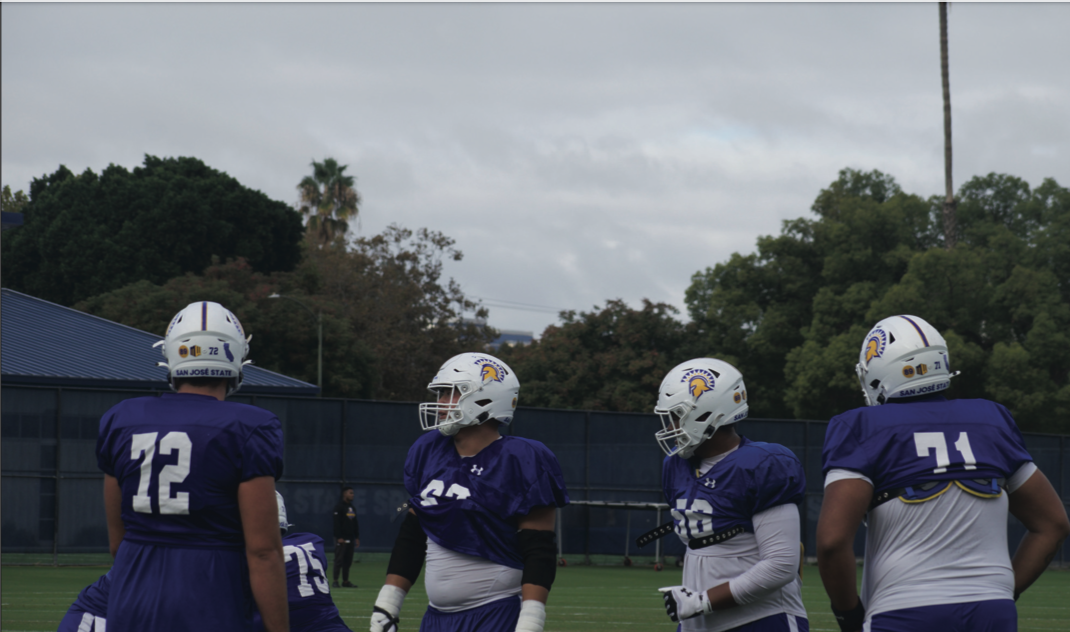 Spartans offensive linemen run drills at Monday morning practice to prepare for the Rainbow Warriors at home.