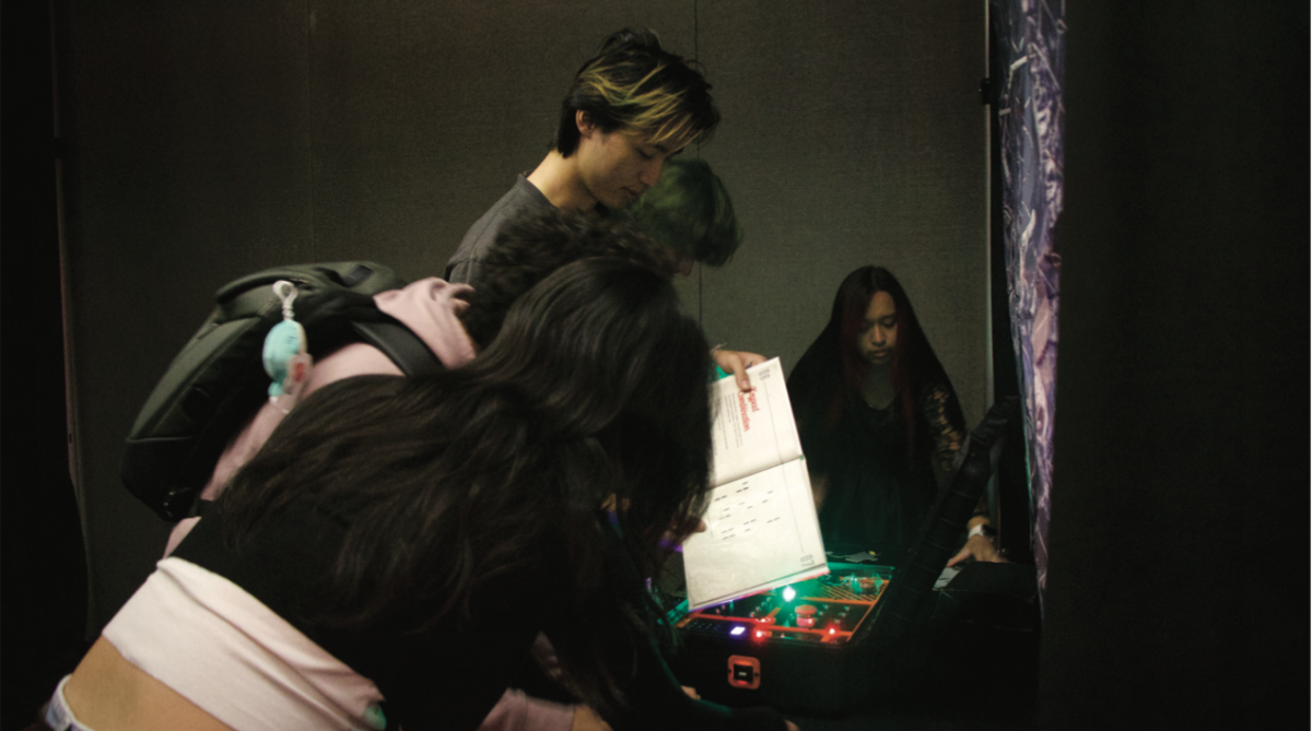 Students band together to go through and solve one of the escape rooms set up in the Student Union Ballroom on Tuesday evening.