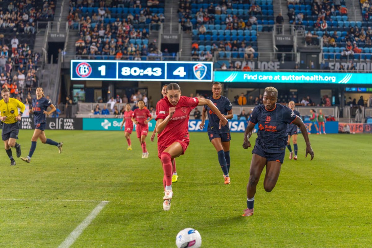 NC Courage defender Maycee Bell (left) and Bay FC forward Racheal Kundananji (right) race toward the ball.