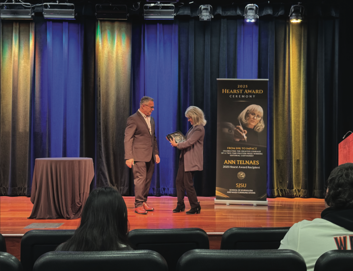 Ann Telnaes, a two-time Pulitzer Prize-winning cartoonist is presented with the 2025 William Randolph Hearst Award by SJSU’s John Delacruz on Wednesday.