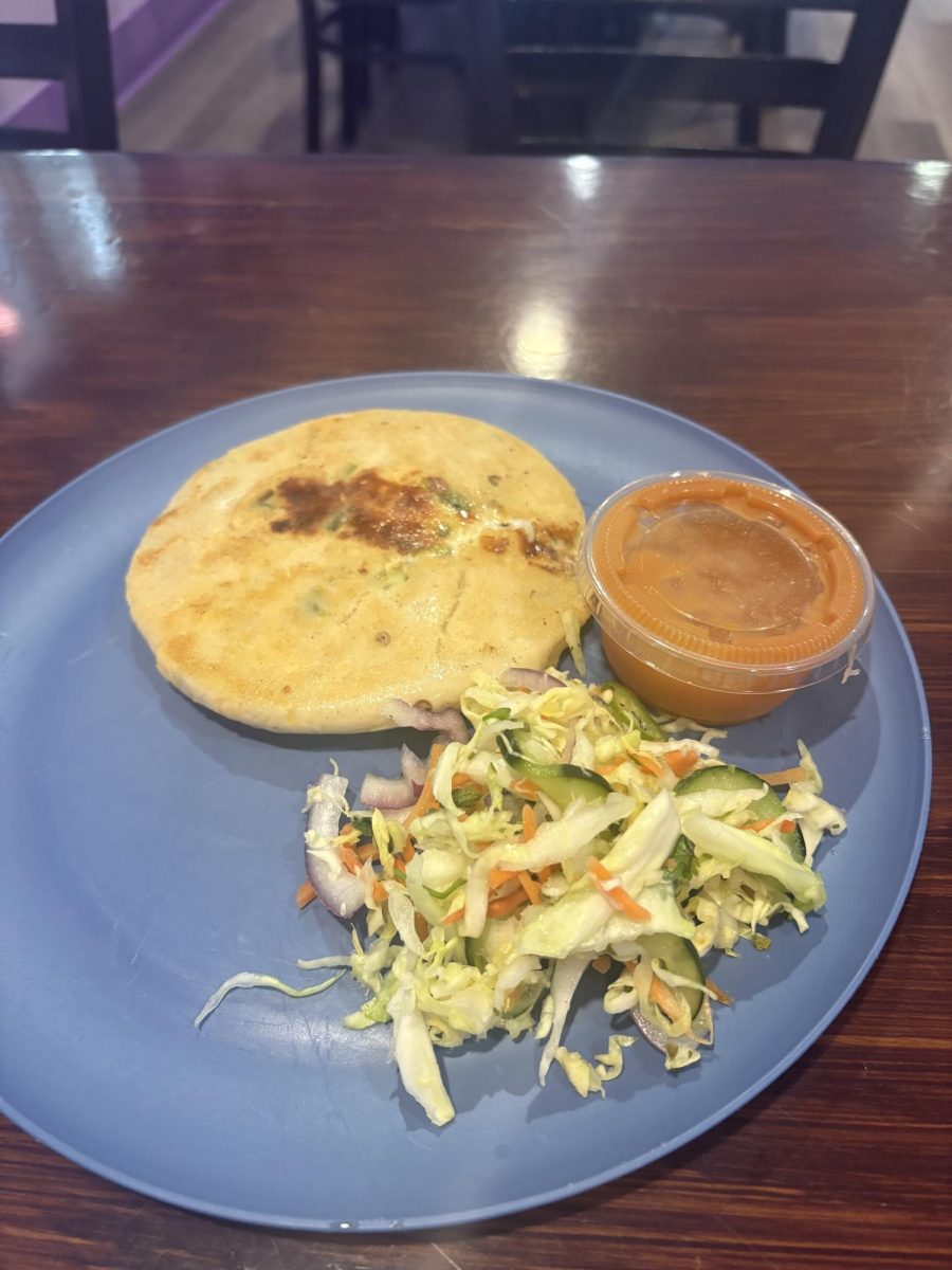 Entre Comales' jalapeño and cheese pupusa comes plated with a small side of salsa roja and curtido. 