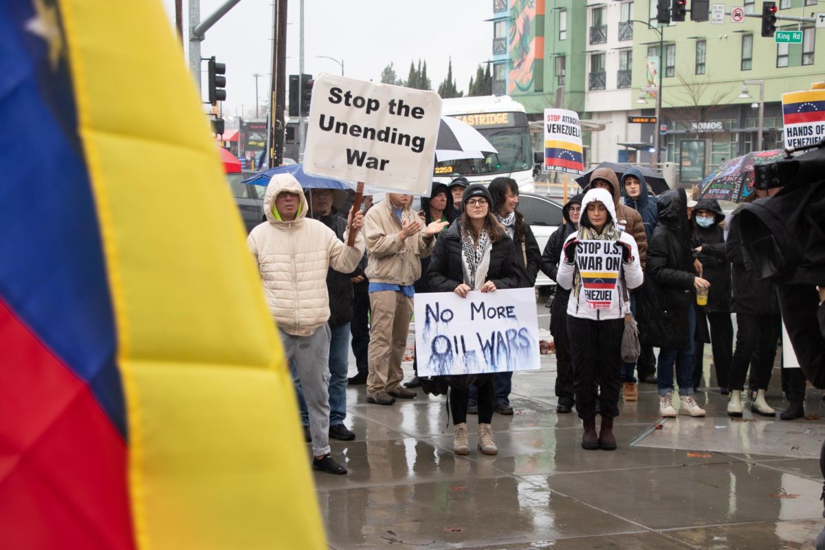 Protesters holding signs and flags gather outside the Mexican Heritage Plaza in East San José to protest the U.S.'s military campaign against Venezuela on Sunday, Jan. 4.