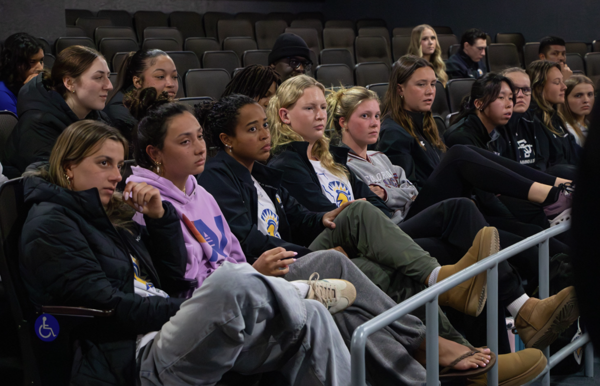 Students and student athletes attend the IRA Open Forum in the Student Union Theater on Tuesday to listen to the conversations of speakers and panelists.