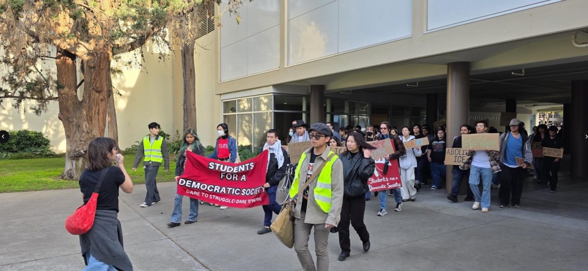Students for a Democratic Society and other organizations march near the Spartan Complex on Wednesday, chanting anti-ICE slogans and displaying signs expressing opposition to ICE messages. 