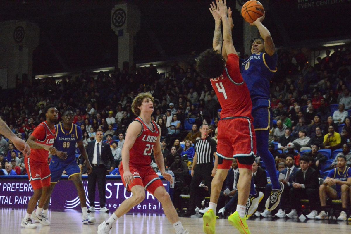 SJSU guard Colby Garland (0) puts up a close range shot while New Mexico guard Uriah Tenette (4) tries to block. 