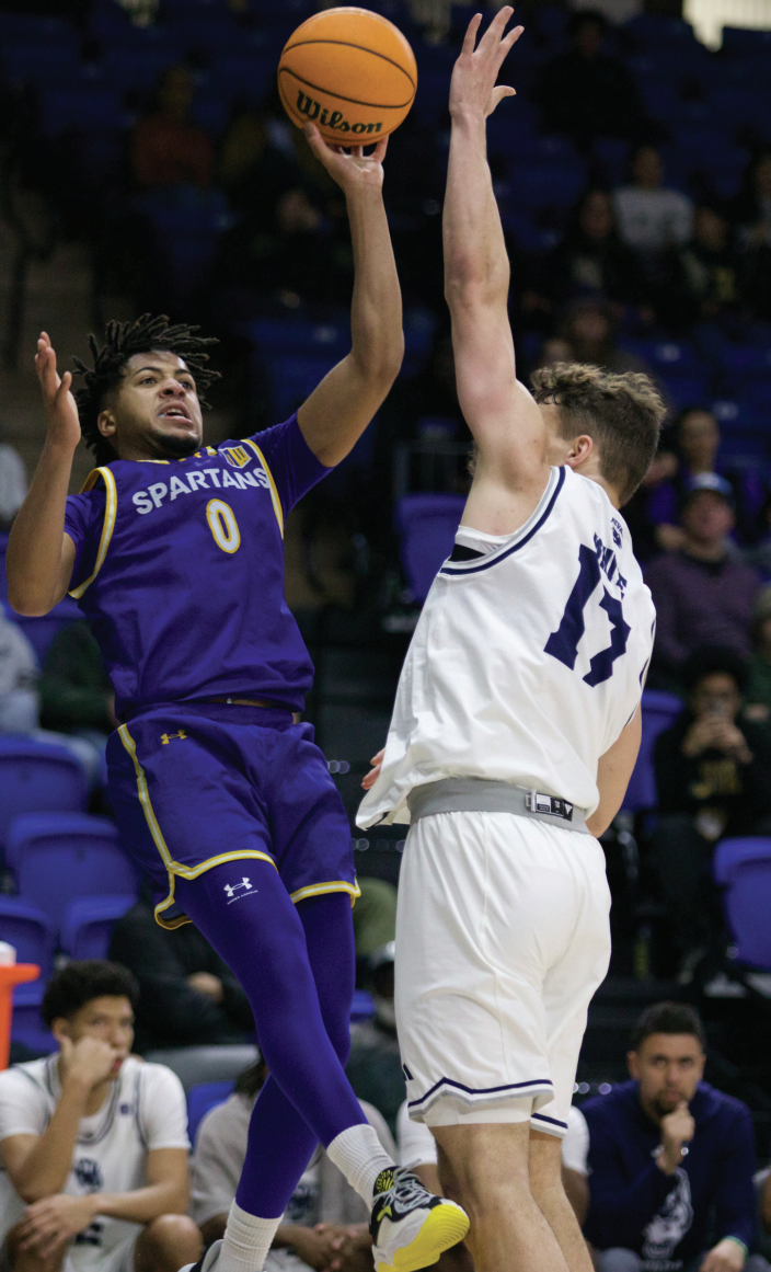 Spartans junior guard Colby Garland (0) attempts a one-handed shot while being guarded by Wolf Pack freshman guard Peyton White (17) during SJSU’s 87-71 win.