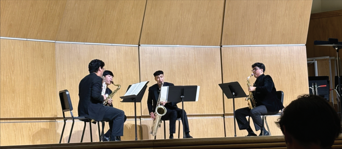 Zácha Quartet's saxophonists, Elijah Reyes, Joseph Andal Jr., David Cortez and Mihir Joshi warm up before their performance. 