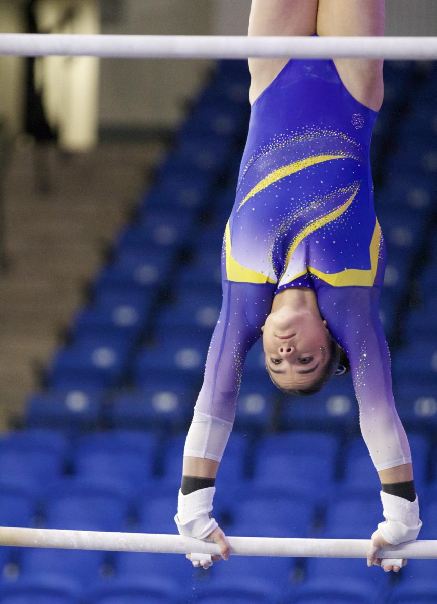 Junior Annabella Carrascosa competes on the uneven bars at Saturday's tri-meet. 
