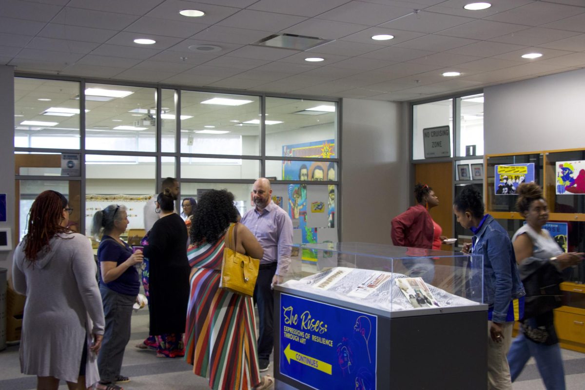 Artists, families and faculty socialize at the “She Rises: Expressions of Resilience through Art” closing reception on Thursday at the Dr. Martin Luther King, Jr Library. “She Rises” highlighted six Black women artists works and poems.
