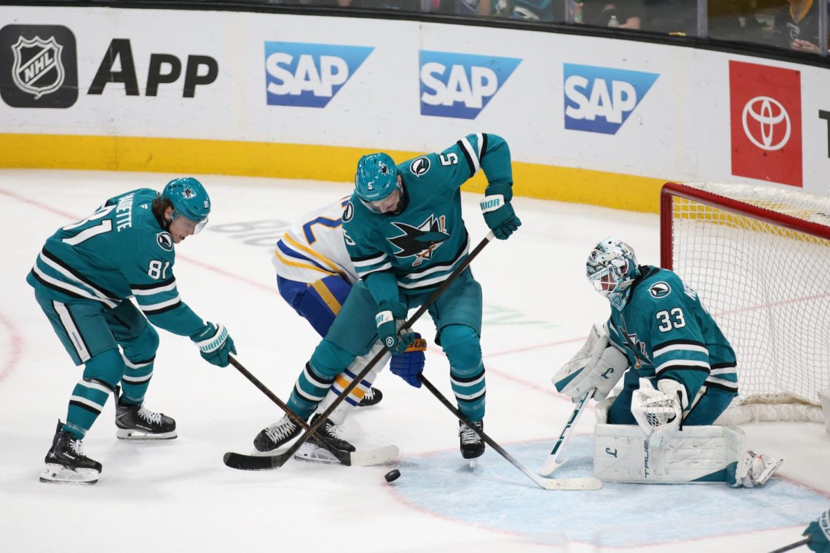Sharks right forward Adam Gaudette and defenseman Vincent Desharnais defend the puck to assist goaltender Alex Nedeljkovic.