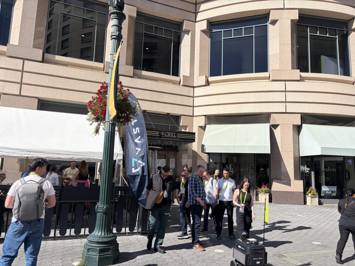 NVIDIA GTC attendees stand outside the restaurant The Grill, which was bought out by VAST Data to hold events during GTC.