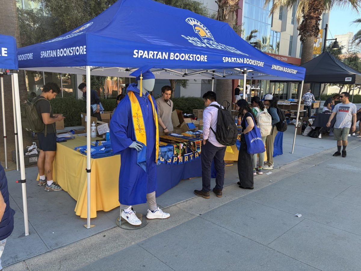 San José State students look at different graduation regalia at Grad Fest on 7th Street Plaza on Tuesday.