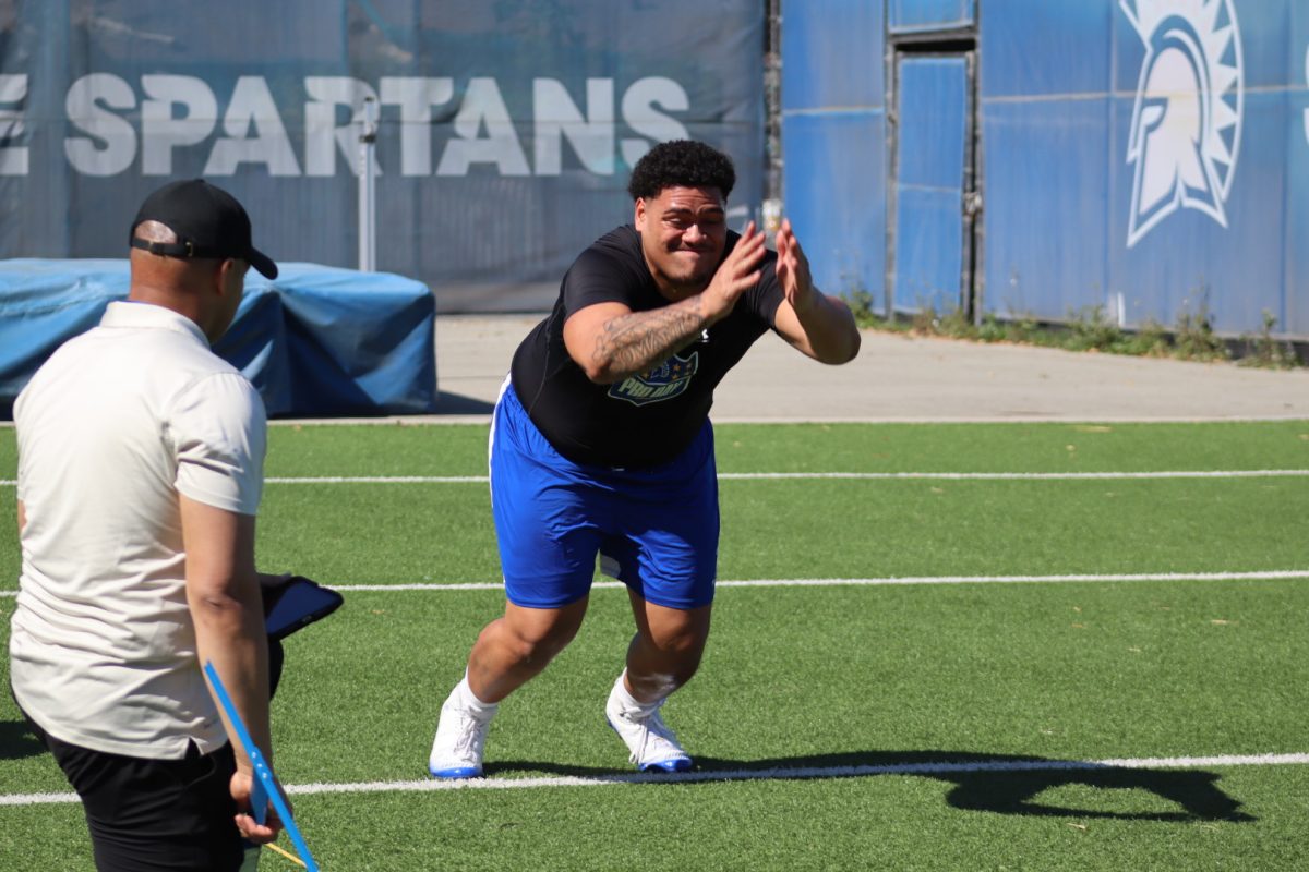 San José State offensive lineman Sione Nomani performs a broad jump (8 feet, 3 inches) as a scout looks on
during the Spartans’ 2026 Pro Day on Wednesday at Koret Athletic Training Center.