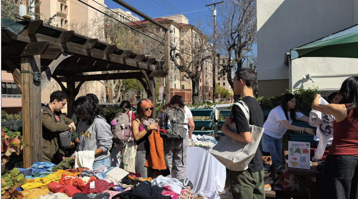 San José State students at the garden look through a variety of clothing donated for the Associated Students clothing swap.