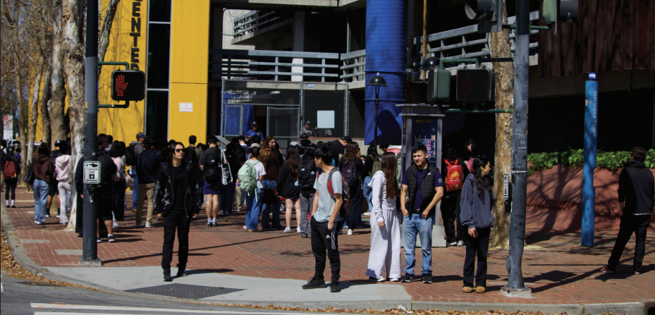 A large crowd of students gathers around the East side of North Garage on 10th Street waiting for
University Police to let them inside. The garage reopened around 3:30 p.m. when police activity concluded. 