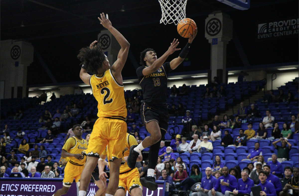 Sophomore guard Jermaine Washington charges the basket to put up a layup during
Saturday’s game. The Spartans finish the regular season 3-17 in conference play.