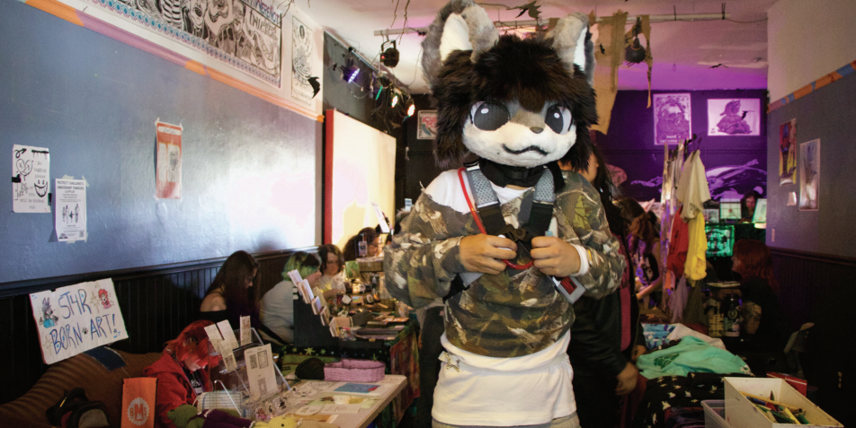 A Furry Mart attendee peruses a room of vendors at the venue Oakland Secret on Sunday.