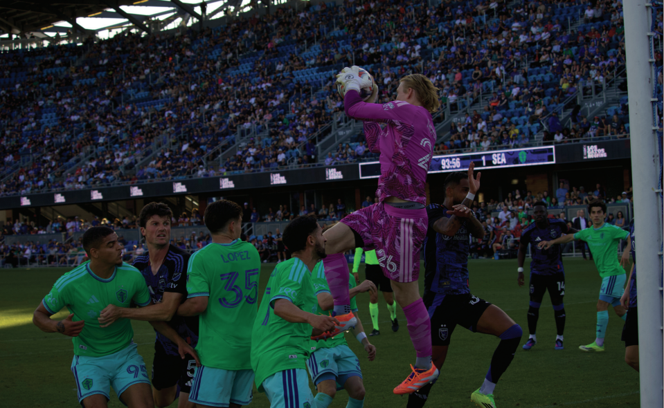 Seattle Sounders goalkeeper Andrew Thomas (26) catches the ball in the air while defending a corner kick.