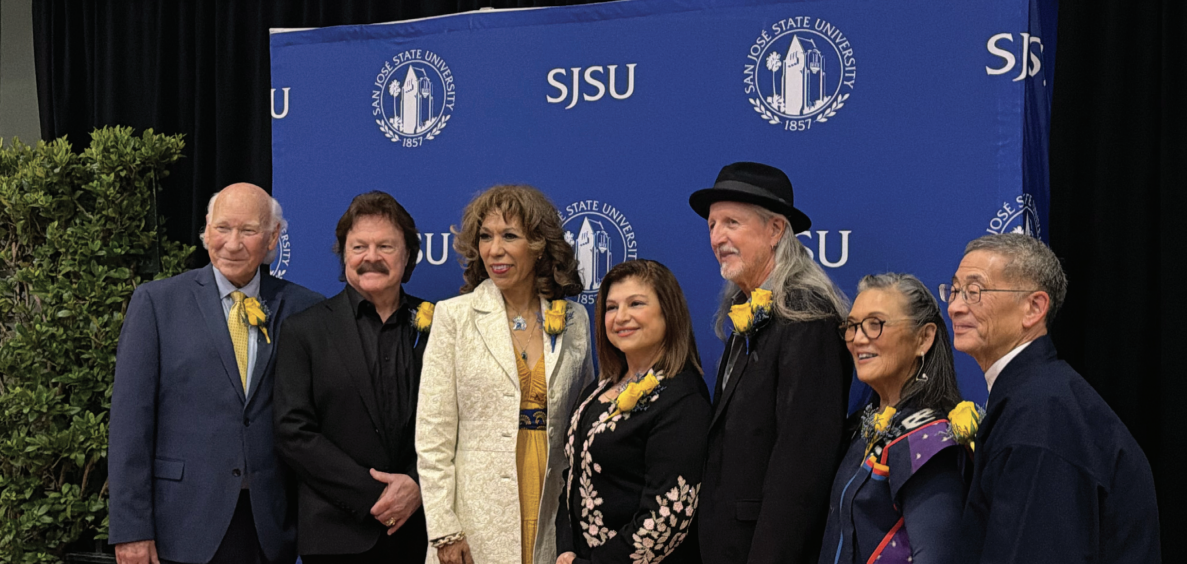 Alumni award winners “Krazy” George Henderson, Tom Johnston, Nora Betyousef Lacey, Patrick Simmons, Patti Jo “PJ” Hirabayashi, Roy Hirabayashi take photos alongside SJSU President Cynthia Teniente-Matson before the Distinguished Alumni Awards begin.