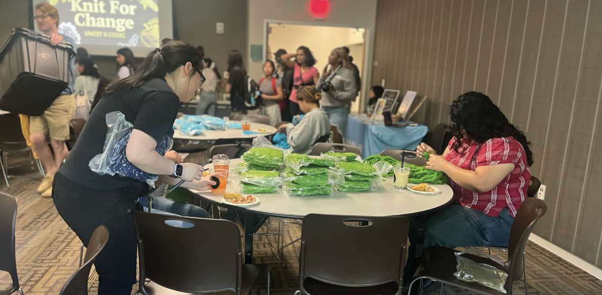 Students attending the César E. Chávez Community Action Center Knit For Change event knitting blankets in the Student Union on Monday.