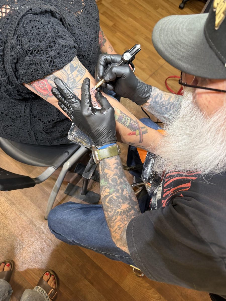 San José Tattoo owner and artist John “Tattoo John” Bullock tattoos a SJ symbol on a client during the San José Day tattoo fl ash day event on Wednesday.