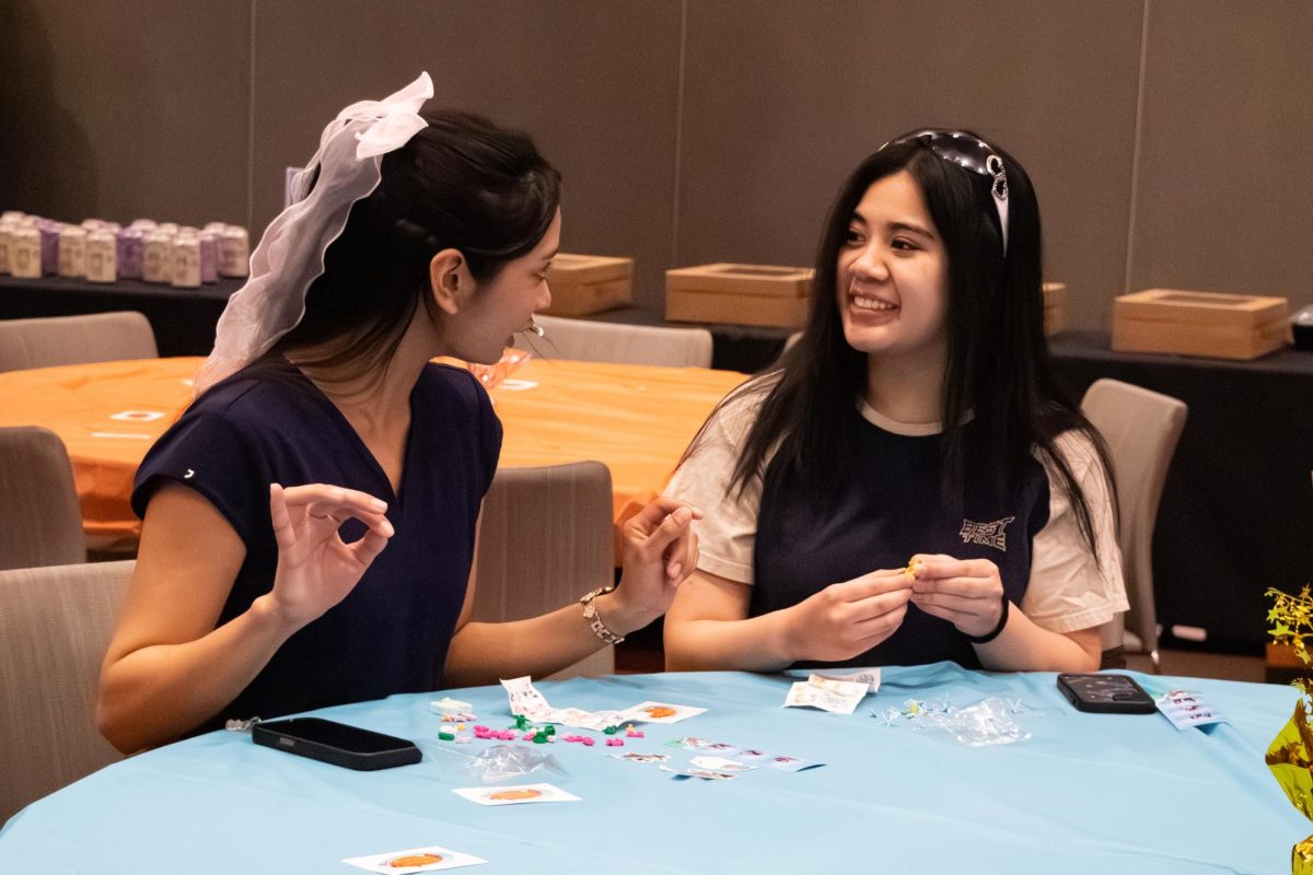 Angelika Yabut, a fourth-year nursing student, and Lauren Tan, a fourth-year nutrition student, build Lego flowers during the “Watcha’ Building” event in the Student Union Ballroom.