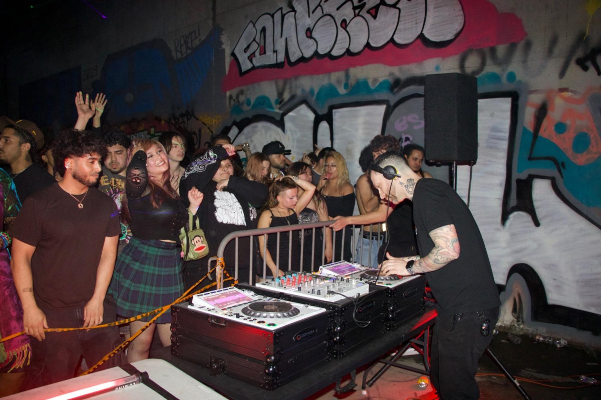 Ravers dance to sounds and beats by DJ and producer Aaron Schwartz (@therealdirtybeats) in a tunnel.