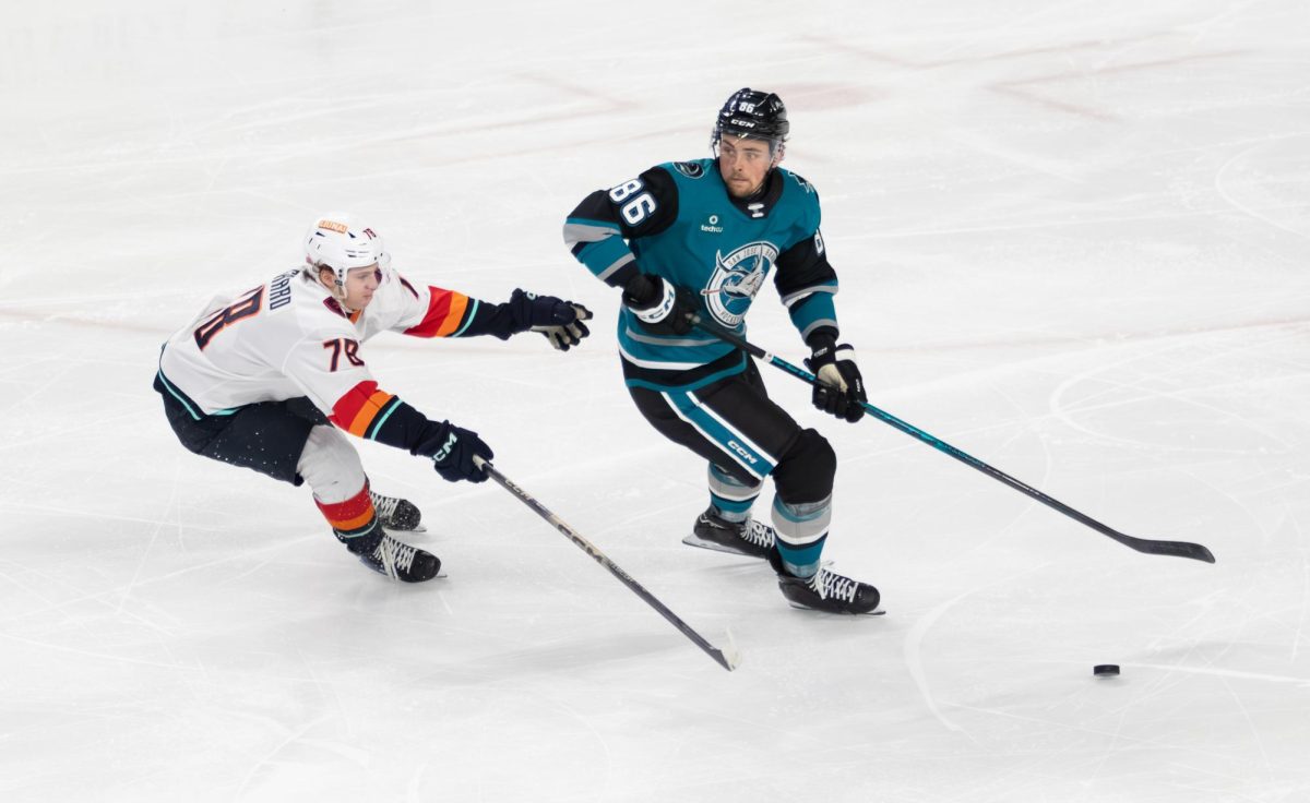 Barracuda defenseman Braden Haché takes the puck past Firebirds forward Oscar Fisker Mølgaard on Tuesday.
