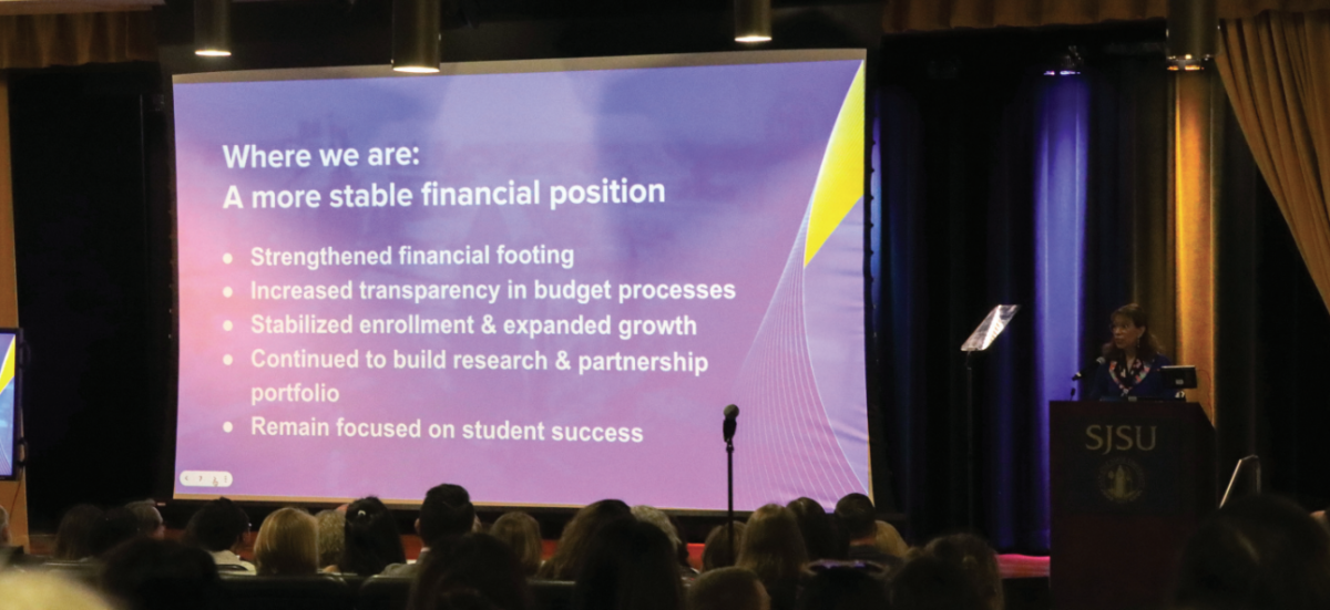 President Cynthia Teniente-Matson speaks at a podium about SJSU’s financial position at the Spring Budget Town Hall meeting in the Student Union Theater on Tuesday.