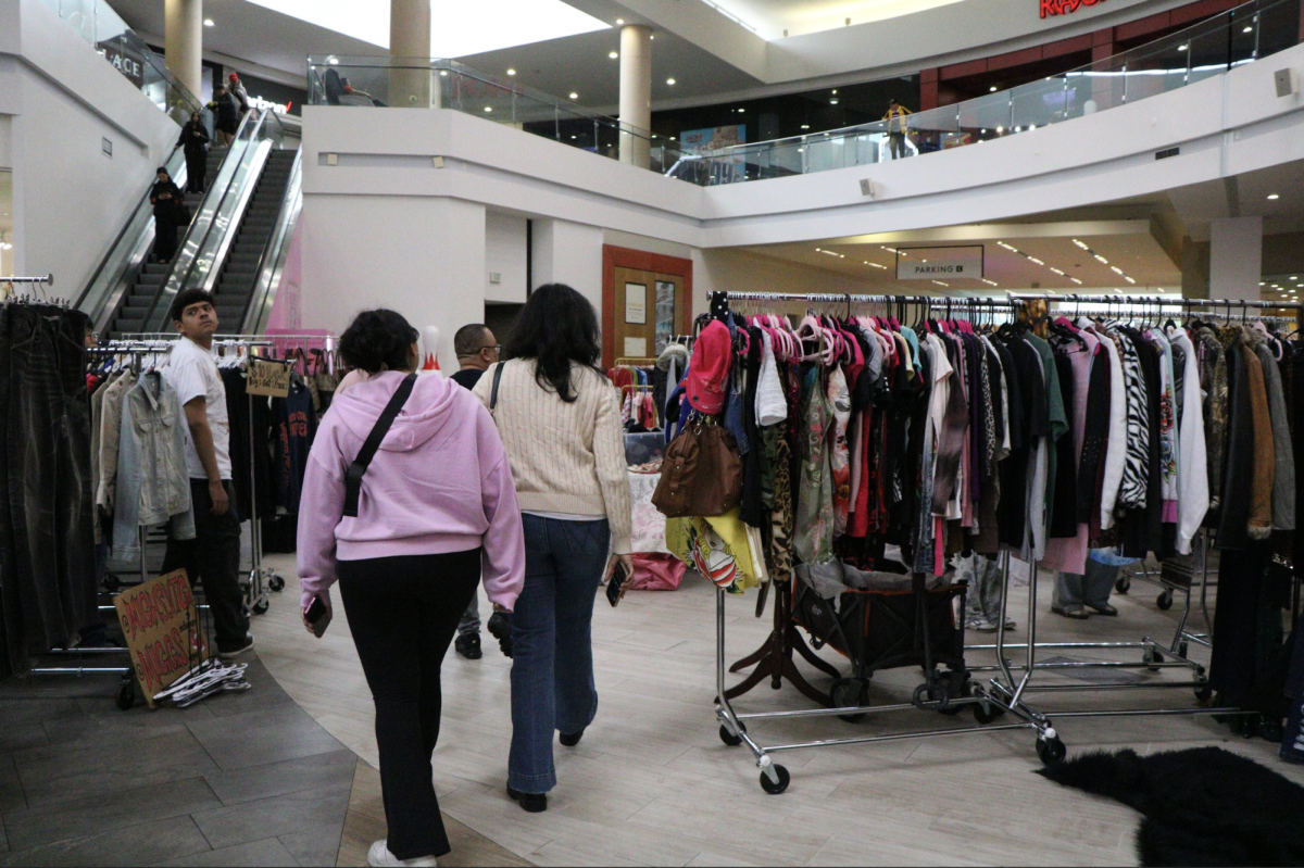 Shoppers browse racks of vintage clothing during the Pop-Up SJ thrift event.