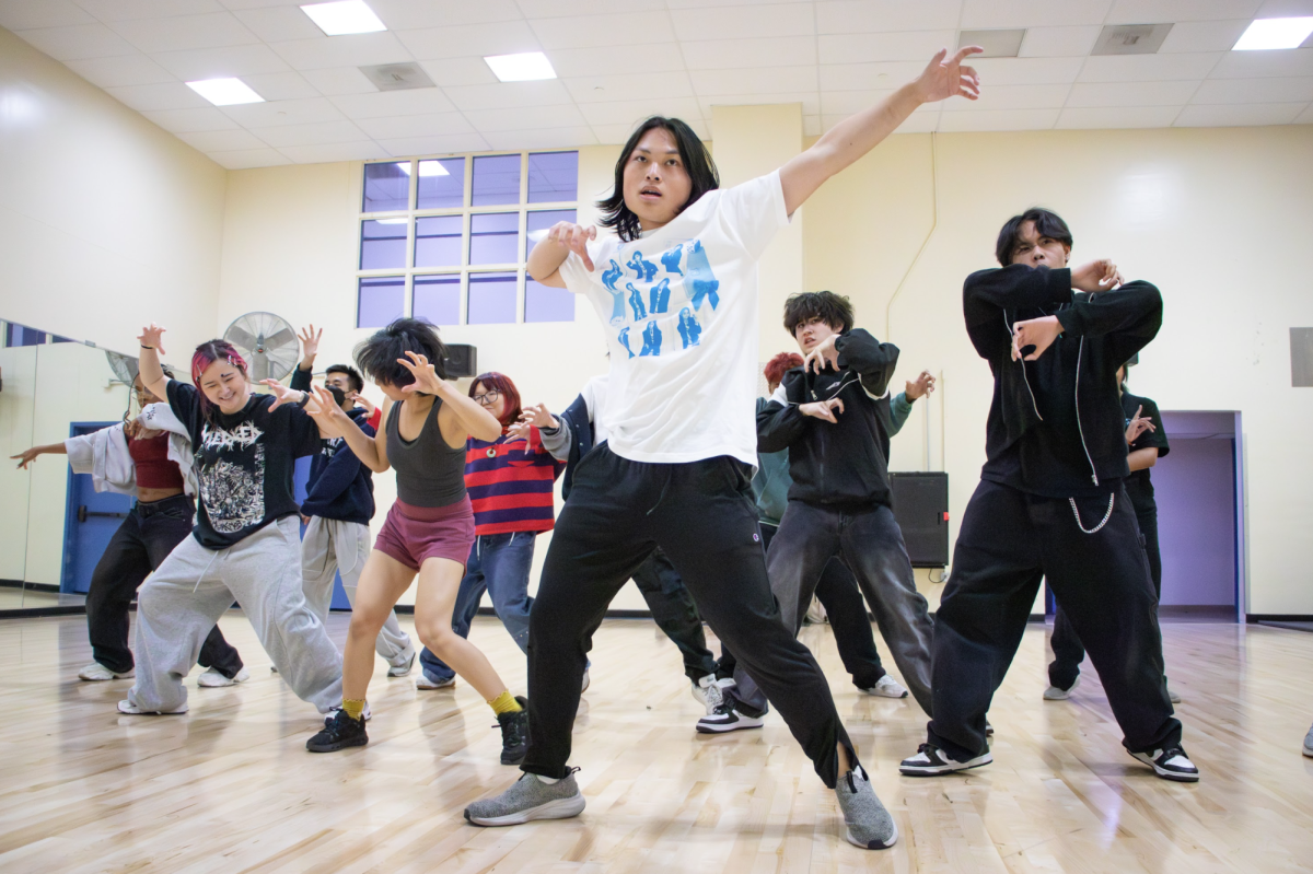 Garrett Yuan, the president of Synkronize Dance, leads a rehearsal for “Drunk-Dazed” by Enhypen in the Provident Credit Union Event Center on March 28.