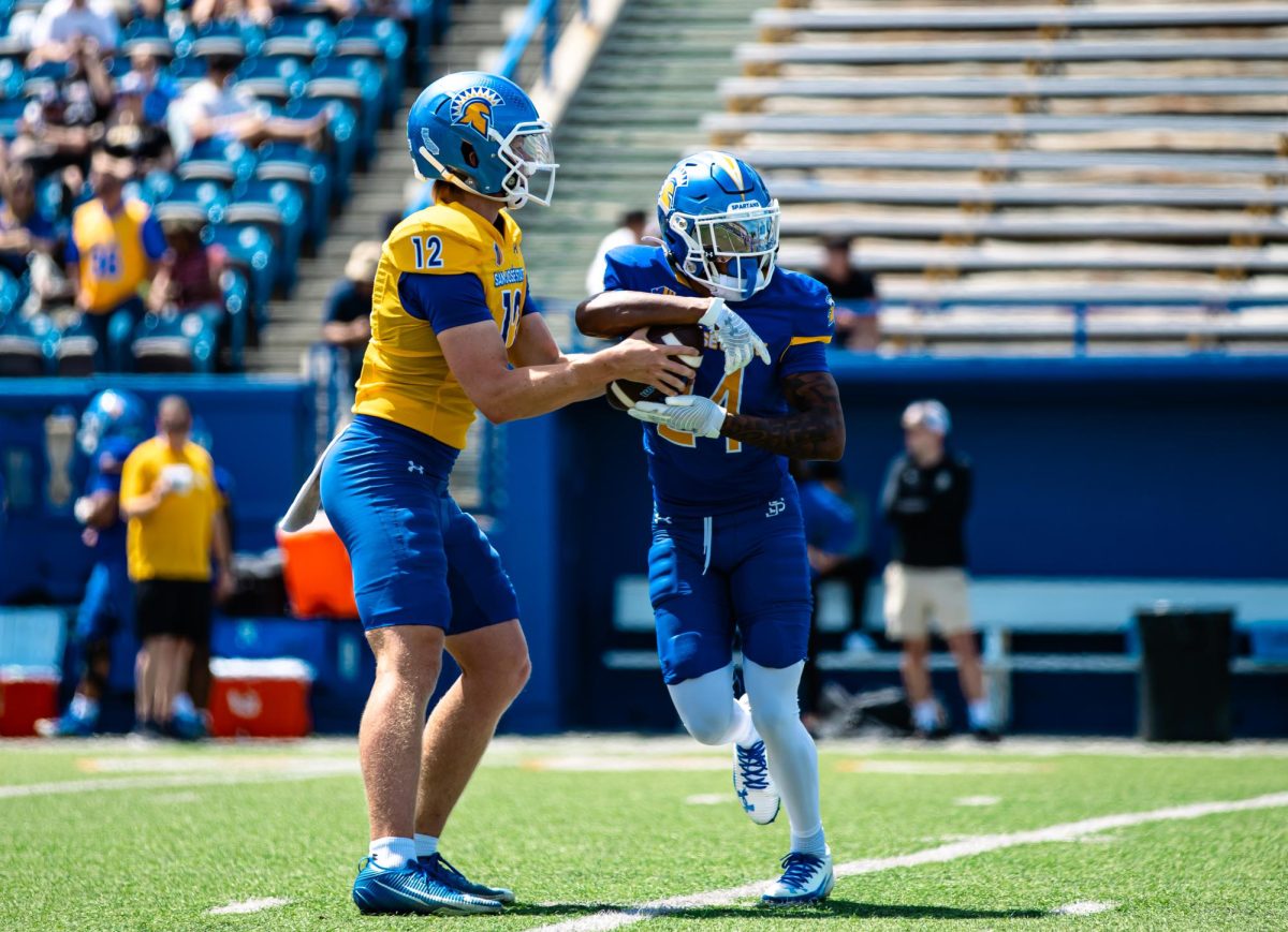 Redshirt freshman quarterback Robert McDaniel (12) hands off the ball to redshirt freshman running back Sir Autry (24) during the spring game on Saturday.