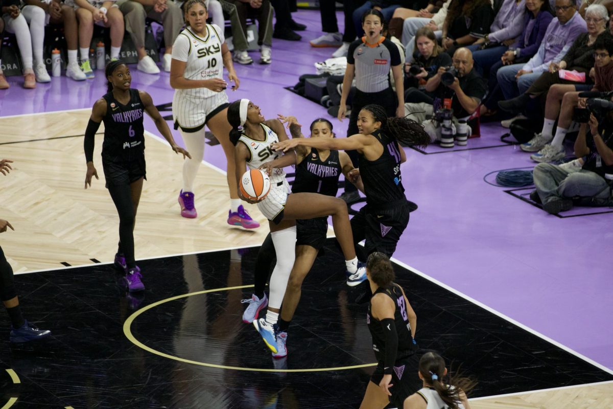 Chicago Sky's Rickea Jackson (5) goes up for a layup while being contested by Golden State Valkyries' Gabby Williams (1) and Kiah Stokes (41).