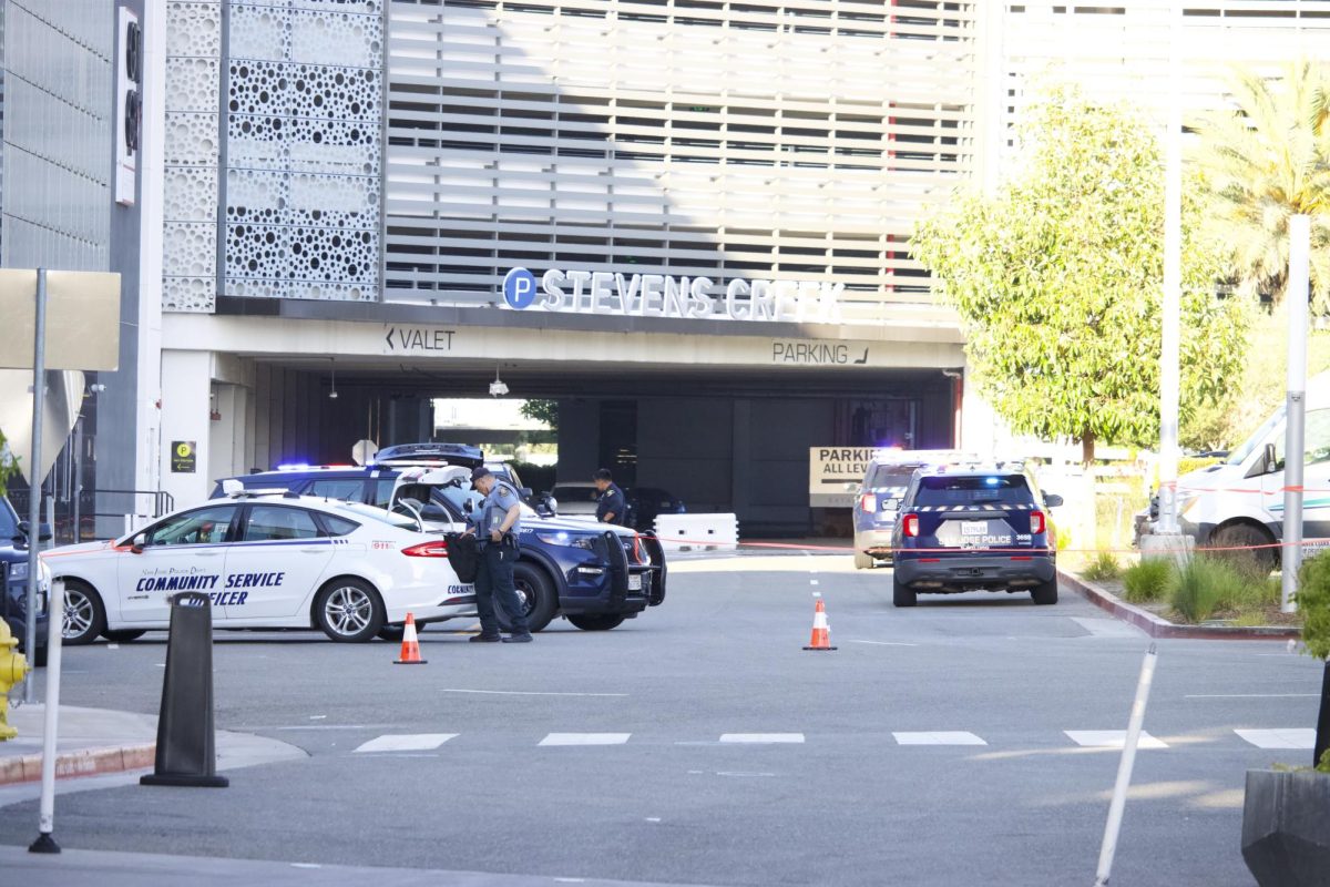 Police officers collect items related to the incident in the Bank of America parking lot outside Valley Fair Mall.